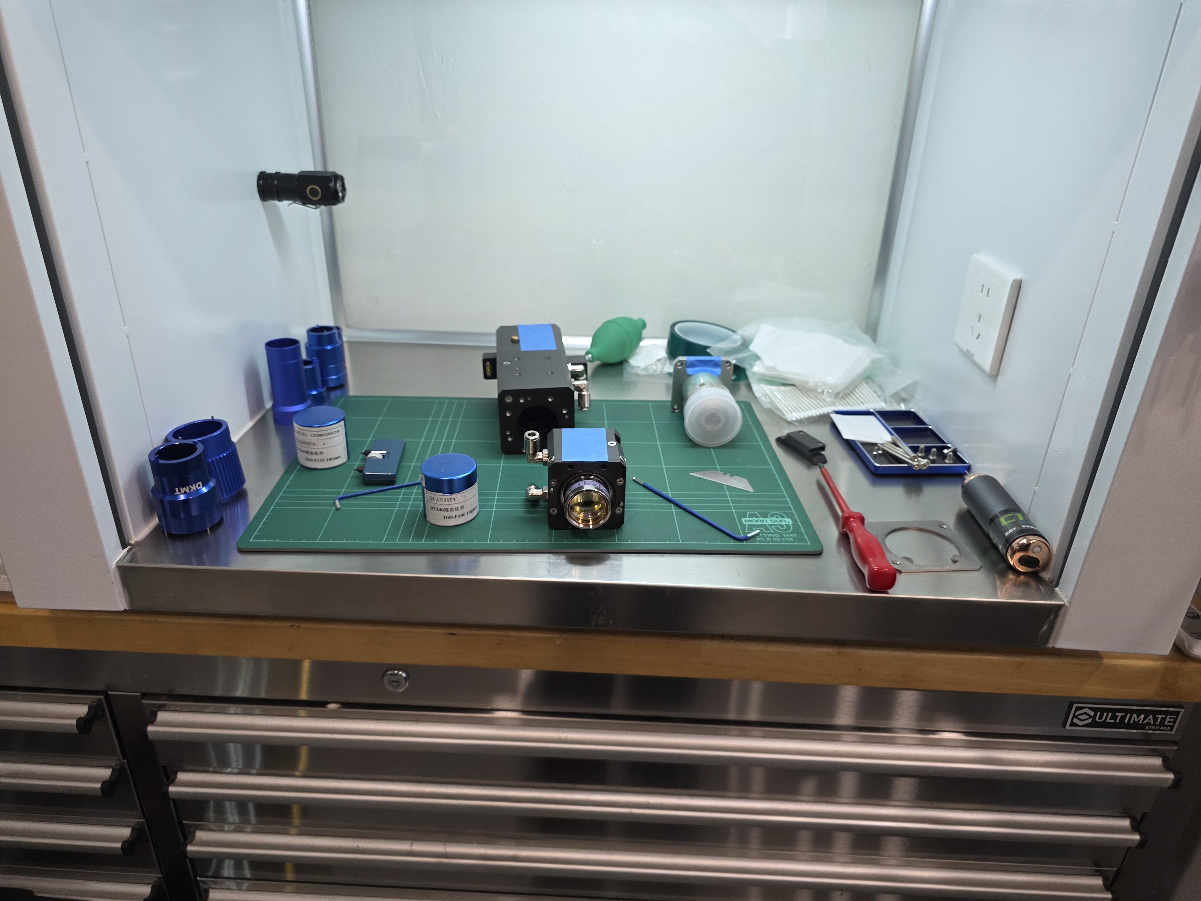 Laser cutting head components on the bench for repair
