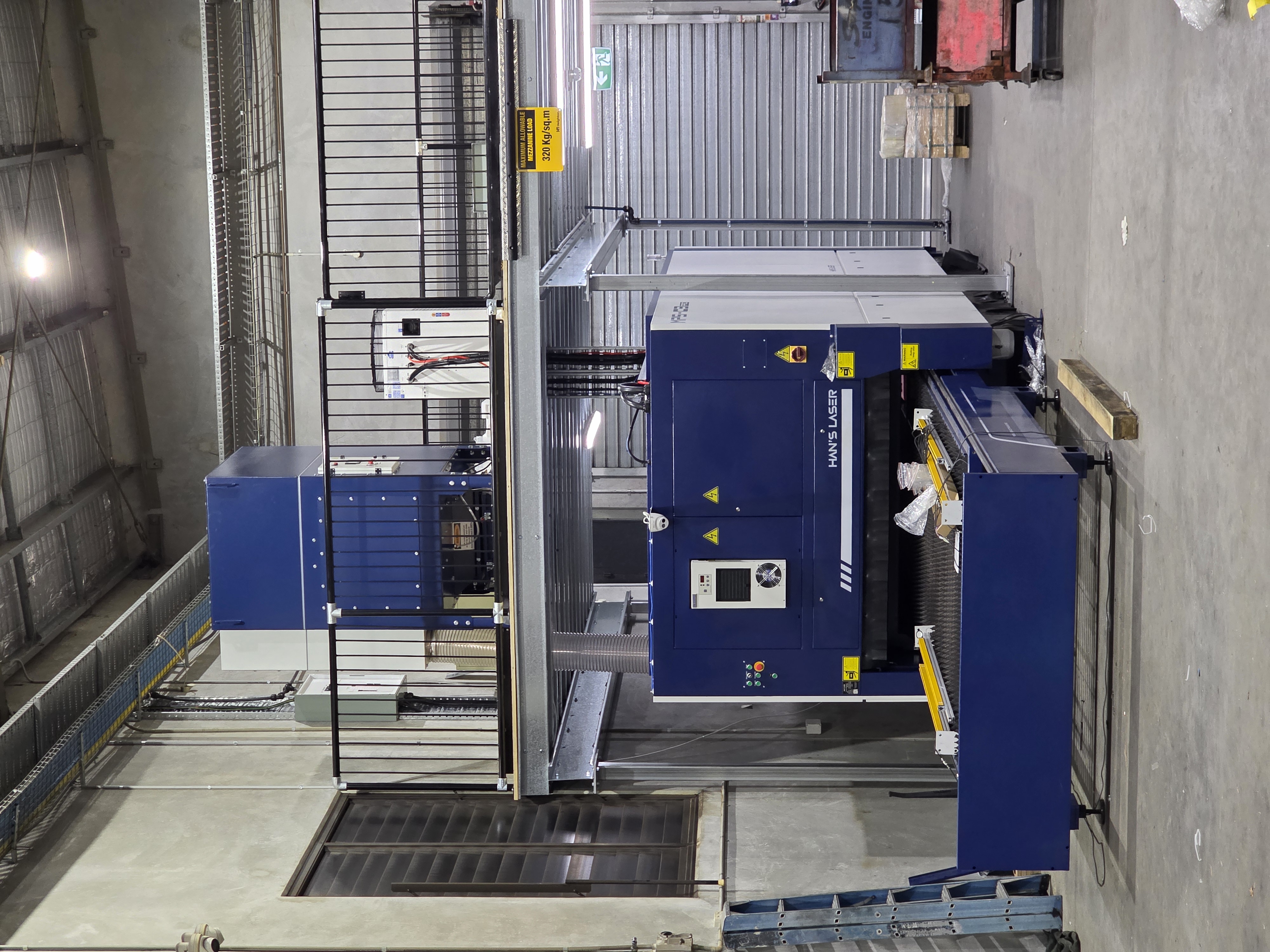 Fibre laser cutting machine installed beneath a mezzanine floor